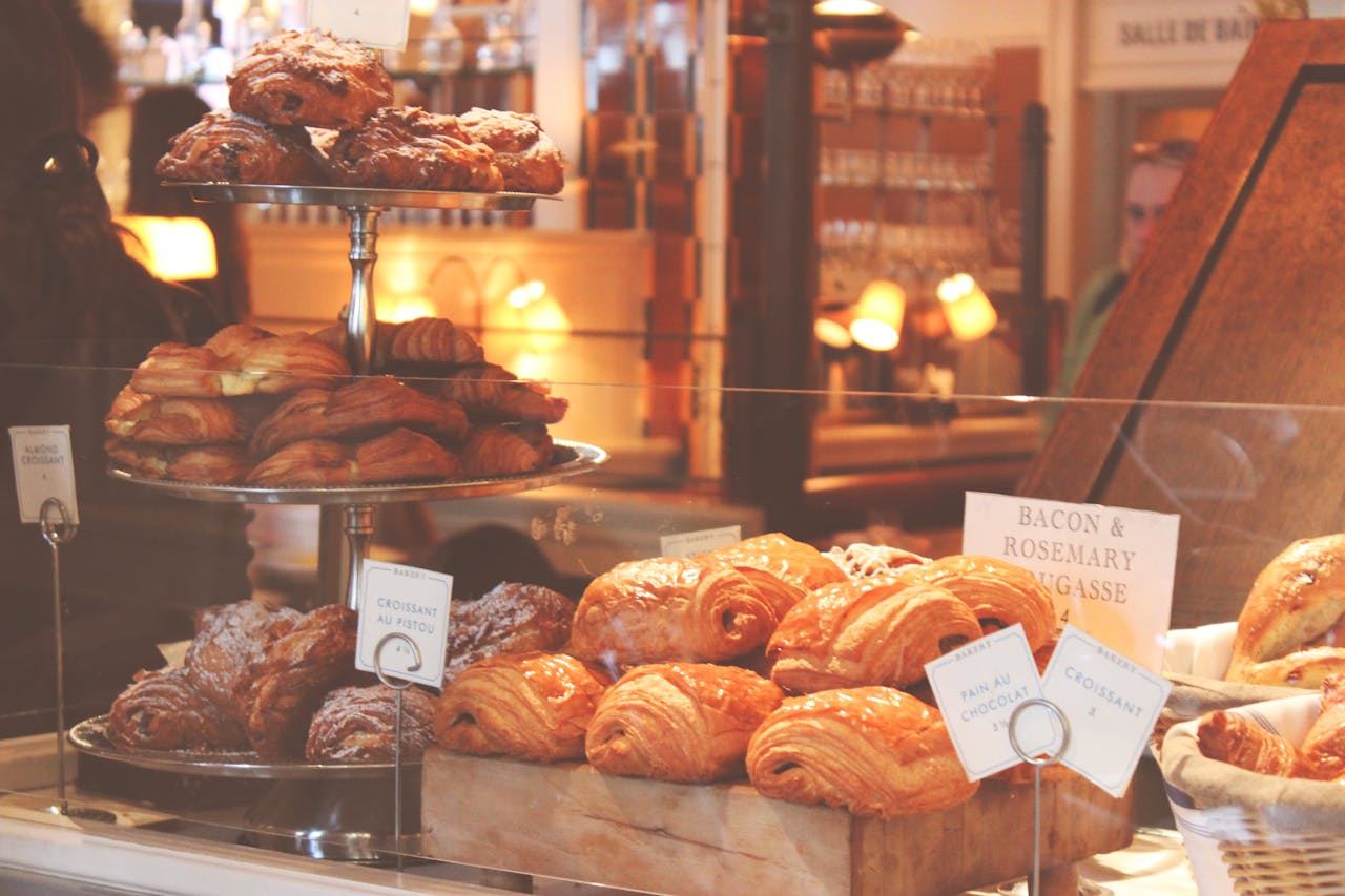 Freshly baked croissants and pastries displayed in a cozy New York City bakery.